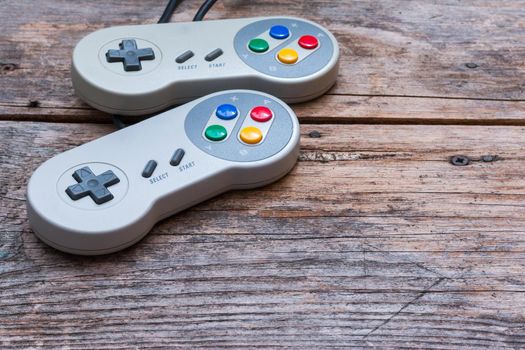 Retro computer gaming controller a rustic wooden background