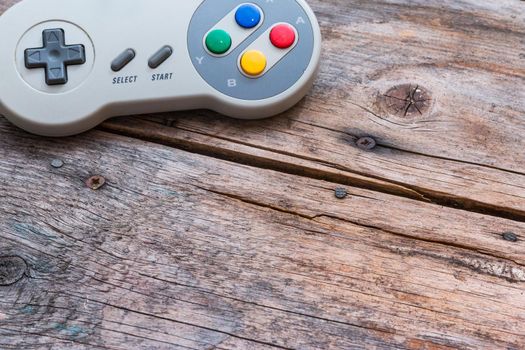 Retro computer gaming controller a rustic wooden background
