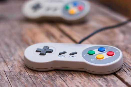 Retro computer gaming controller a rustic wooden background