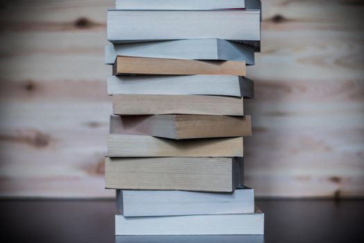 Stack of books on wooden background, knowledge and science