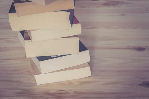 Stack of books on wooden background, knowledge and science