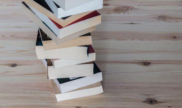 Stack of books on wooden background, knowledge and science