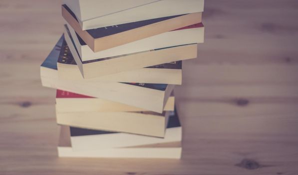 Stack of books on wooden background, knowledge and science