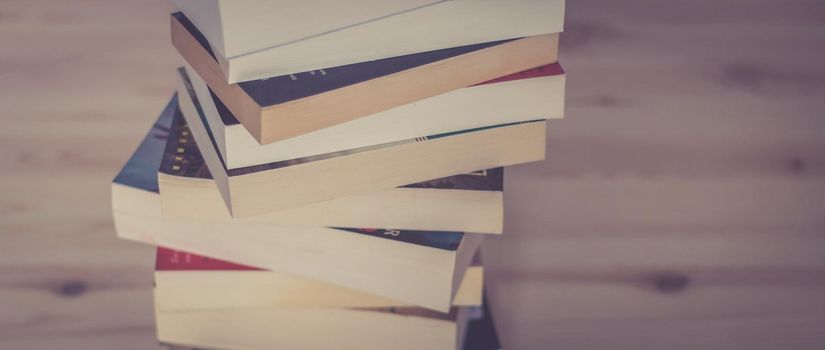 Stack of books on wooden background, knowledge and science