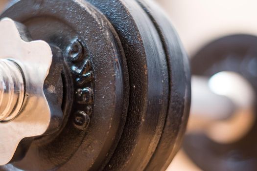 Black bar bell on the wooden floor, physical exercise