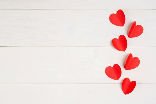 Heart shape with red paper on white wooden background, celebration and anniversary with symbol of love, holiday and festive, top view, flat lay, copyspace, valentine day concept.