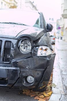 Close up of black damaged car, front view