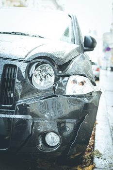 Close up of black damaged car, front view