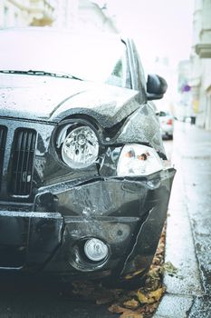 Close up of black damaged car, front view