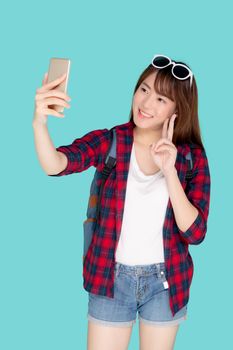 Beautiful portrait young asian woman cheerful smiling and take selfie on smart mobile phone, beauty girl wear travel summer enjoy and fun in vacation isolated on blue background, holiday concept.