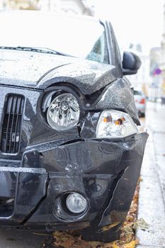 Close up of black damaged car, front view