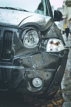 Close up of black damaged car, front view