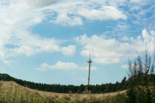 Clouds with wind generator, photo effect with distortion filter against blue sky. Concept global networking