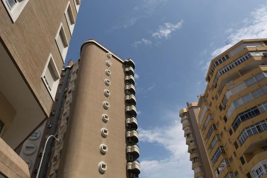 View of the modern multi-storey apartment buildings and sky view. Low angle view of building in downtown Malaga