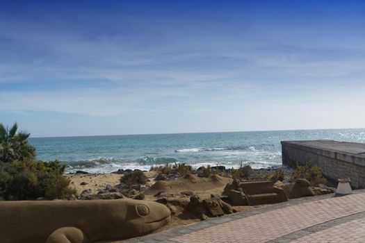 Sand sculptures on the beach of Meloneras, Spain with inscription Gran Canaria