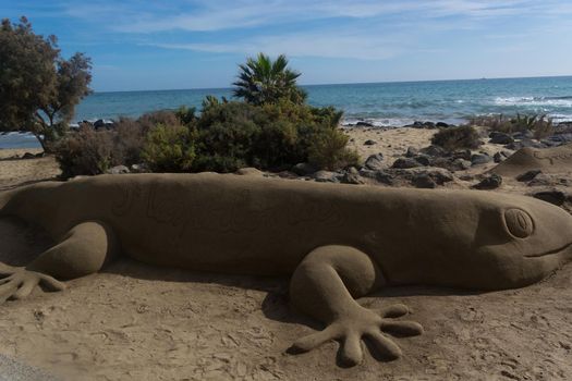 Sand sculptures on the beach of Meloneras, Spain with inscription Gran Canaria