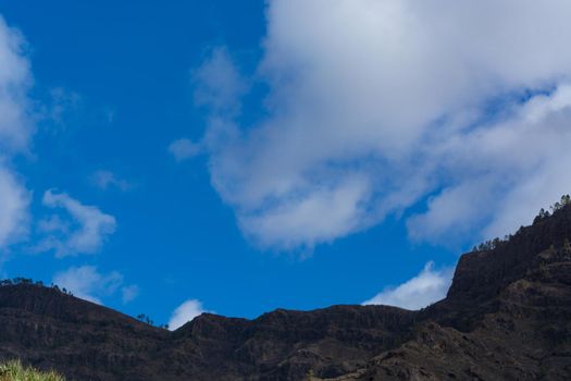 Mountains on the coast between Puerto de Mogan and Puerto Rico. Layers of volcanic rock.