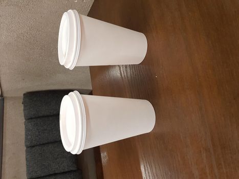 Side view of empty disposable takeaway coffee cup on a table