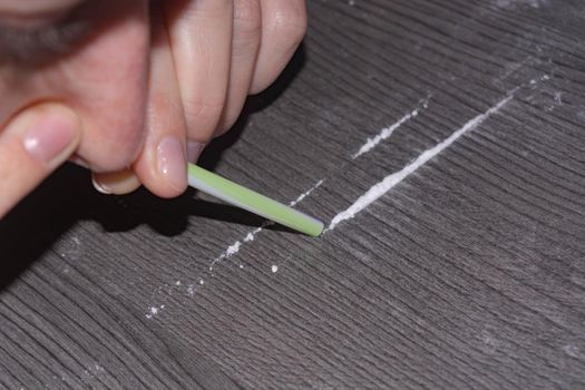 Substance abuse and drug use and sniffing cocaine powder, close-up  