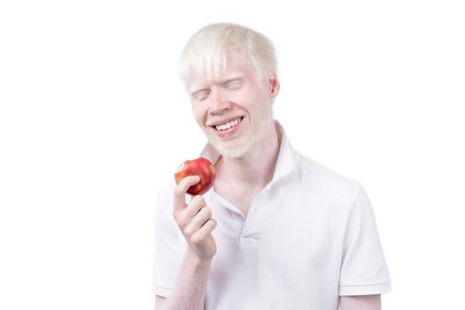 albinism albino man white skin hair studio dressed t-shirt isolated white background. abnormal deviations. unusual appearance. skin abnormality Beautiful people with special appearance. Eat red apple