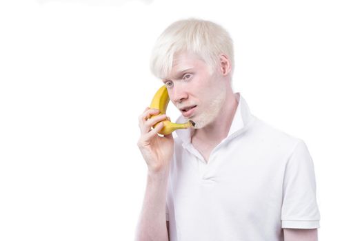 Happy albino man white skin hair studio dressed t-shirt isolated white background. abnormal deviations unusual appearance abnormality Beautiful people with special appearance. use banana as a phone