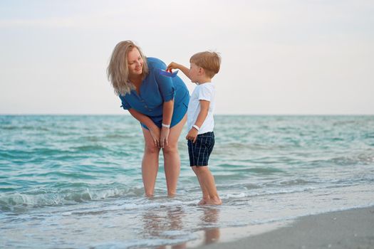 Mother son spending time together sea vacation Young dad child little boy walking beach Mother day. Family with one child. Happy childhood with mommy. Walking ocean wave