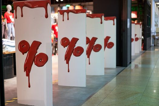 Percentage sign at the entrance to the store denoting seasonal discounts Sale concept Real life. Shopping mall