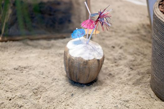 Coconut coctail standing sand sea beach Travel concept