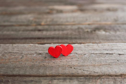 Small red hearts on wooden background with copy space