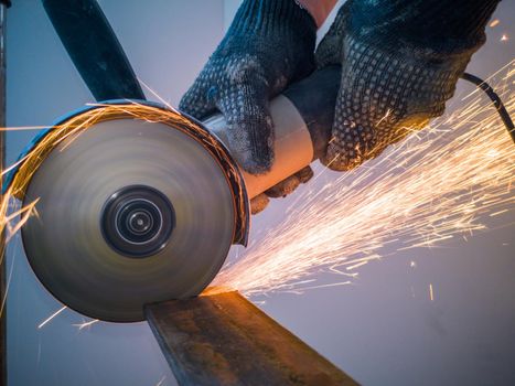 Sawing metal with circular saw sparks close up