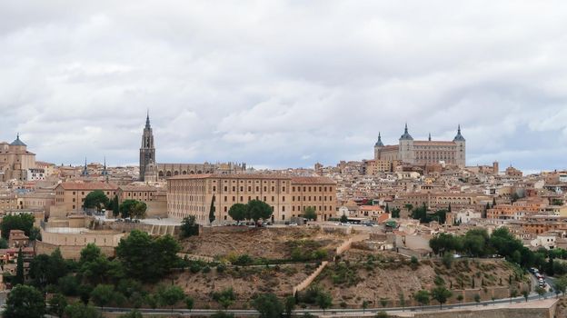 A mesmerizing shot of a beautiful cityscape and ancient castle of Toledo in Spain