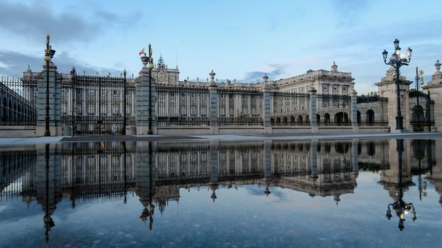 Royal Palace in Madrid reflecting in water after a rainy day, Spain. Reflection of Royal Palace