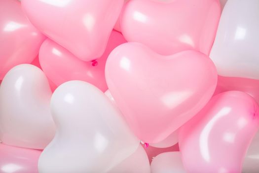 Happy valentines day greetings many heart shaped pink and white balloons background