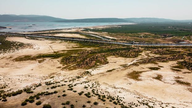 aerial drone shoot from side of an old lake - white sands and plain background - orange is dominant color. photo has taken at bafa lake in turkey.