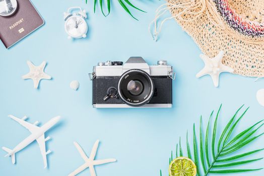 Flat lay top view mockup retro camera films, airplane, passport, starfish, shells traveler tropical accessories on a blue background with copy space, Vacation summer travel and business trip concept