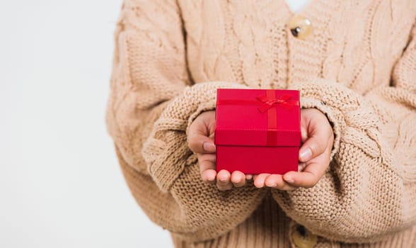 Valentine Day. Female beauty hands holding small gift package box present wrapped paper with ribbon isolated on white background, Christmas, New year, Birthday holiday background concept