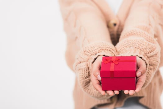 Valentine Day. Female beauty hands holding small gift package box present wrapped paper with ribbon isolated on white background, Christmas, New year, Birthday holiday background concept