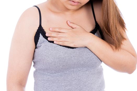 Woman touching her heart or chest isolated white background. Healthcare medical or daily life concept.