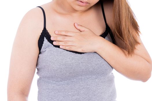 Woman touching her heart or chest isolated white background. Healthcare medical or daily life concept.