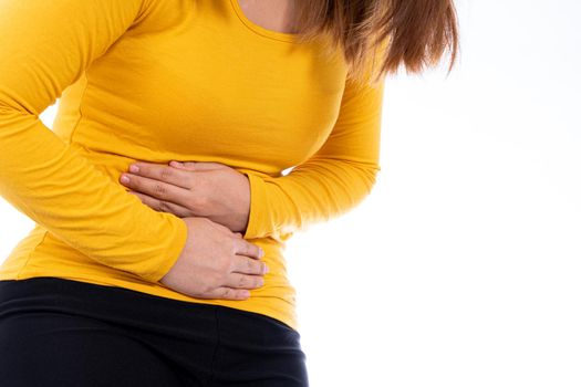 Woman suffering from stomach pain and injury isolated white background. Health care and medical concept.