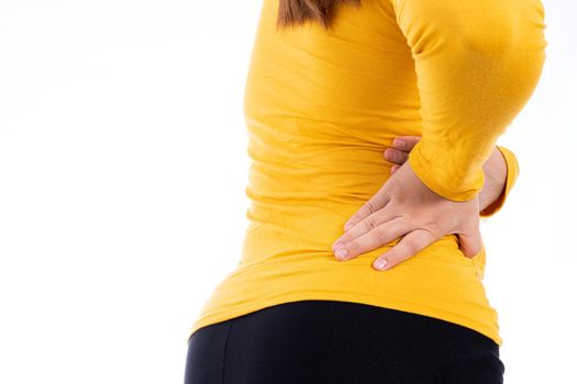 Woman suffering from waist and back pain isolated white background. Health care and medical concept.