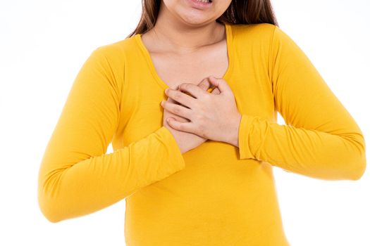 Woman touching her heart or chest isolated white background. Healthcare medical or daily life concept.