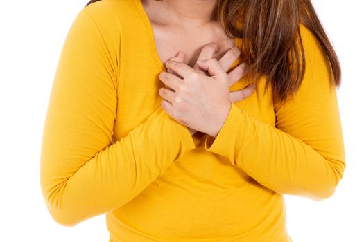 Woman touching her heart or chest isolated white background. Healthcare medical or daily life concept.