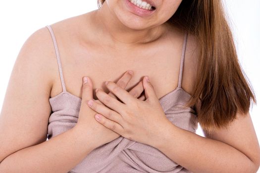 Woman touching her heart or chest isolated white background. Healthcare medical or daily life concept.