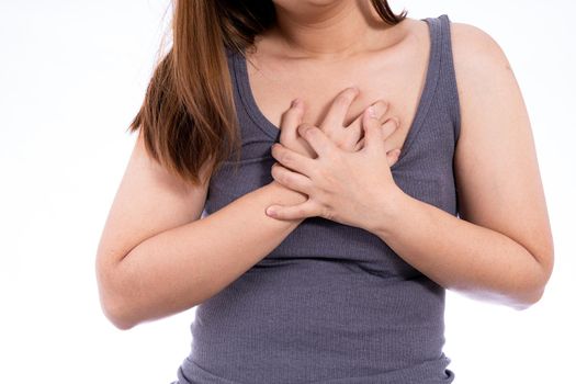 Woman touching her heart or chest isolated white background. Healthcare medical or daily life concept.