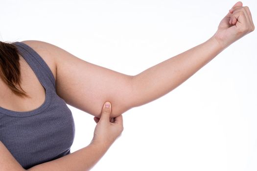 Woman holding excessive fat arm isolated white background. Woman pinching arm fat flabby skin. Weight loss, slim body, healthy lifestyle concept.