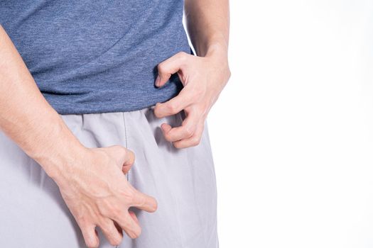 Man hands scratching his crotch isolated white background. Medical, healthcare for advertising concept.