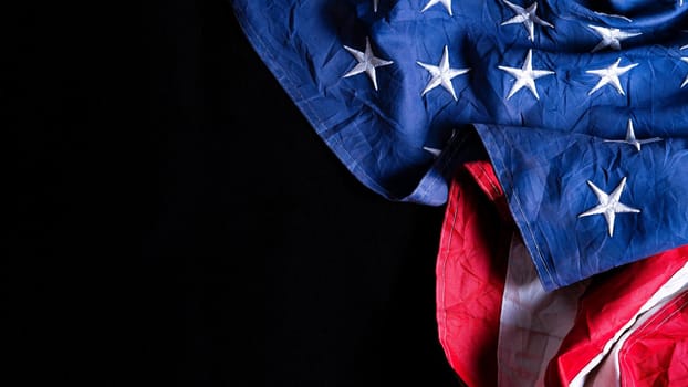 US American flag against black background. For Memorial, Presidents, Veterans, Labor, Independence or 4th of July celebration day. Top view, copy space for text.