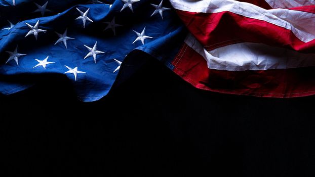 US American flag against black background. For Memorial, Presidents, Veterans, Labor, Independence or 4th of July celebration day. Top view, copy space for text.