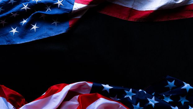 US American flag against black background. For Memorial, Presidents, Veterans, Labor, Independence or 4th of July celebration day. Top view, copy space for text.